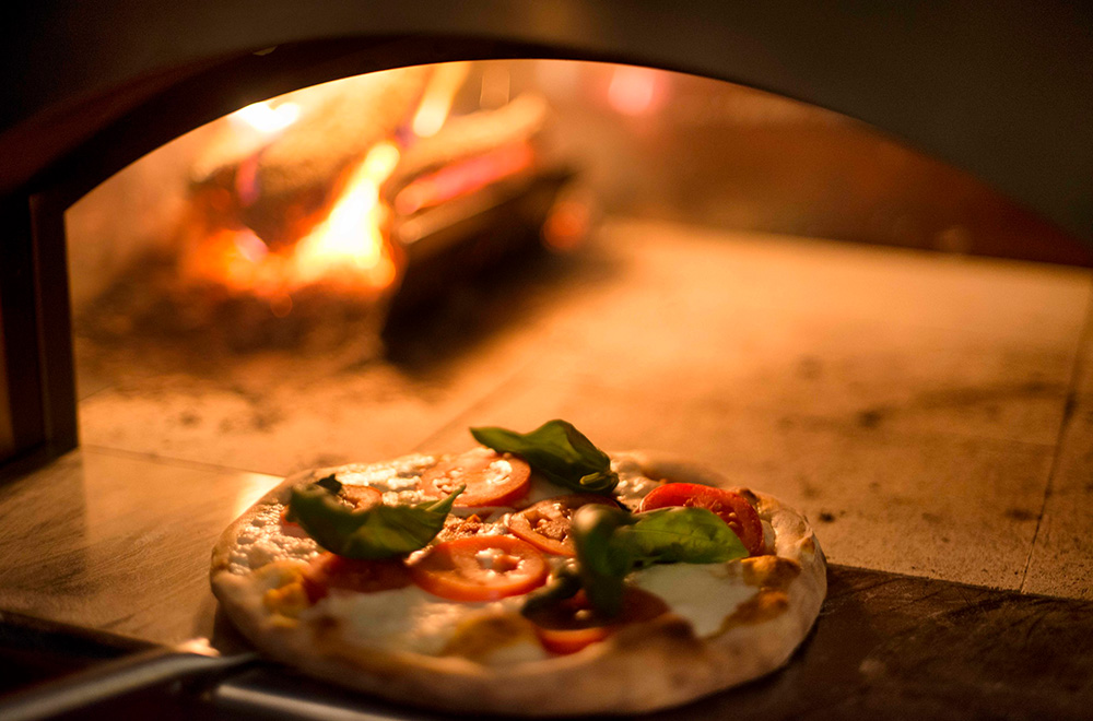 Stone pizza oven with pizza cooking